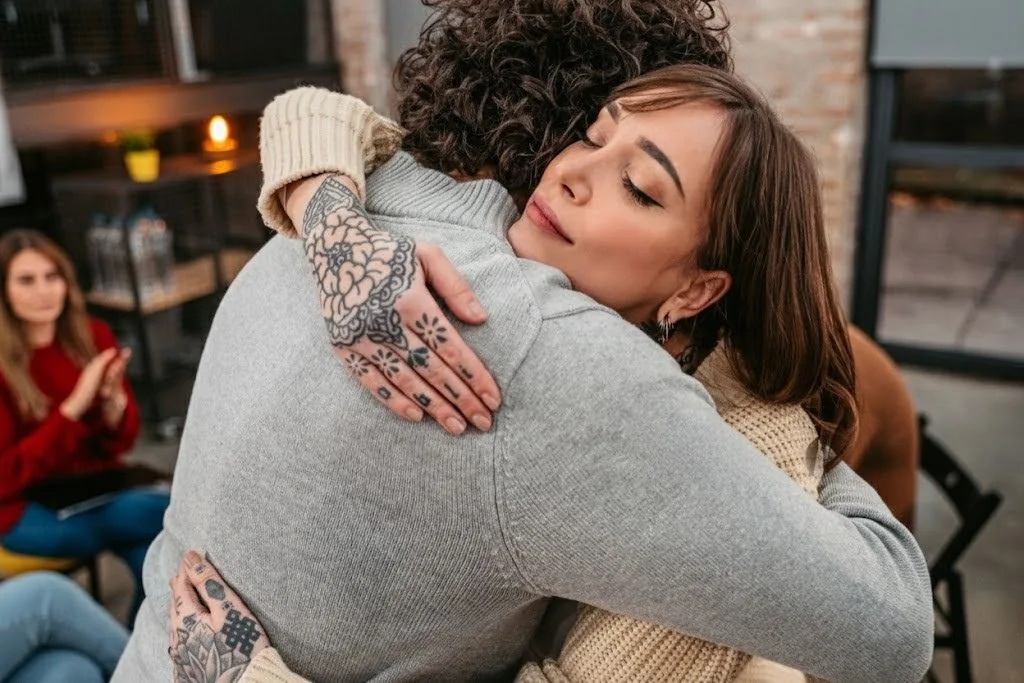 Two people embracing in a supportive moment
